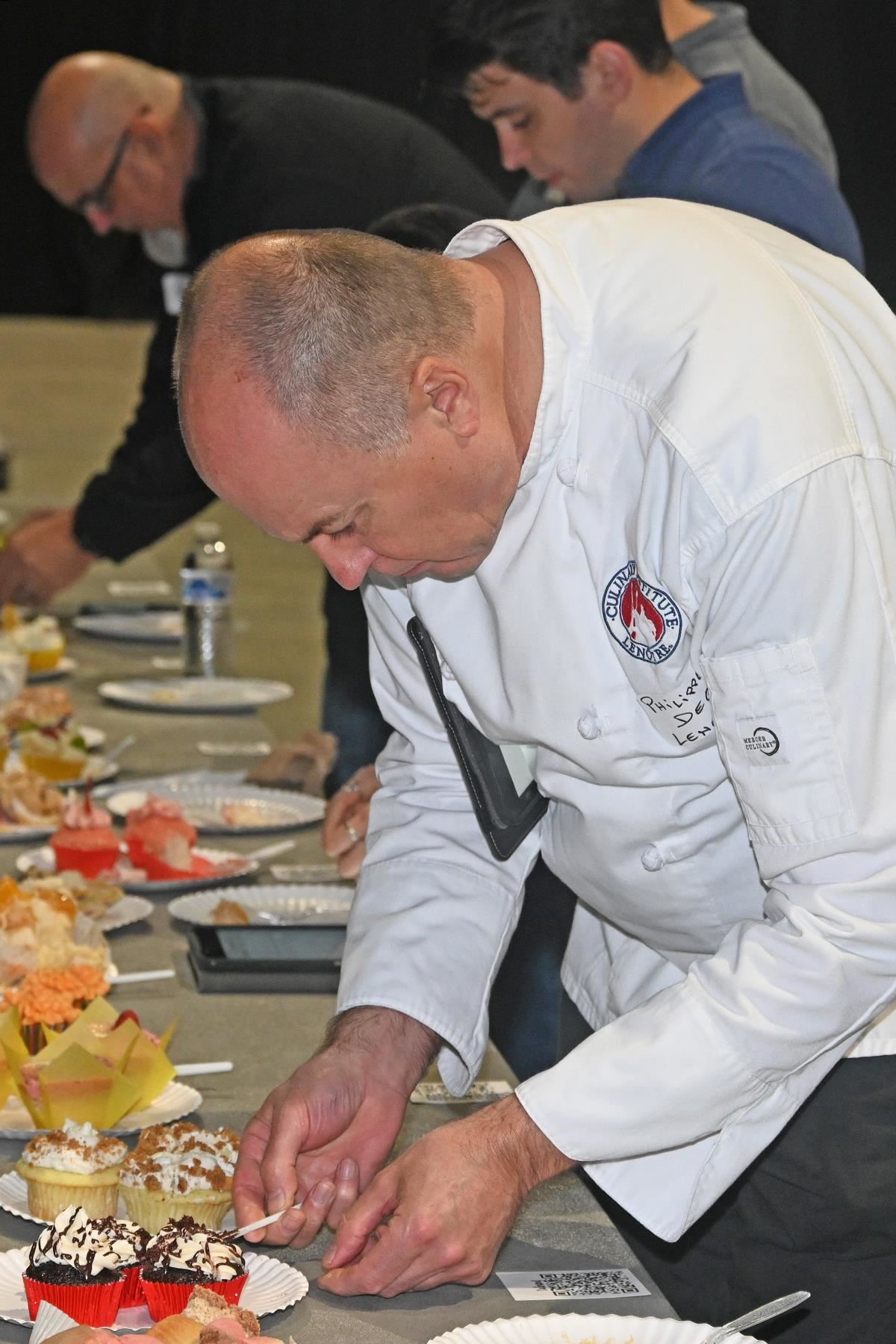 Philippe Dege, a pastry chef and instructor at the Culinary Institute Lenotre, judges cupcakes at the Cupcake Battle.
